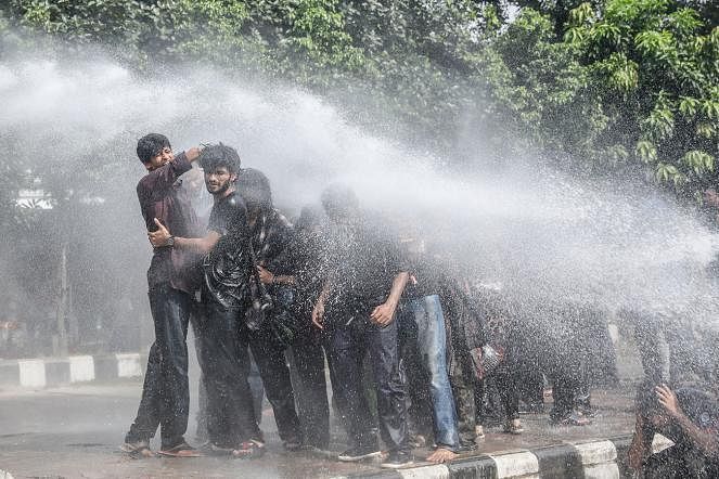 Protesting students drenched in hot water from a water-cannon by the police on 6 August in Shahbagh, Dhaka. Photo: Prothom Alo