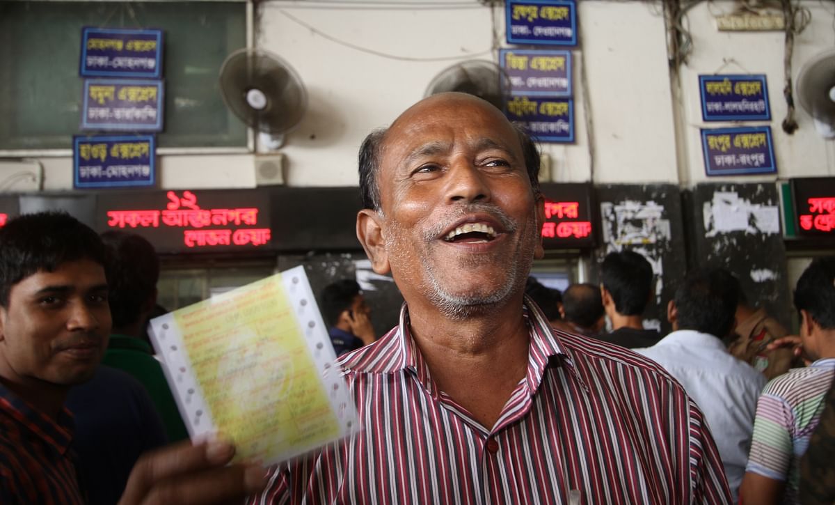 A person exhilarated for getting advance train ticket of desired date for Eid ul-Azha journey. The 8 August photo was taken from Kamalapur Railway Station, Dhaka. Photo: Abdus Salam