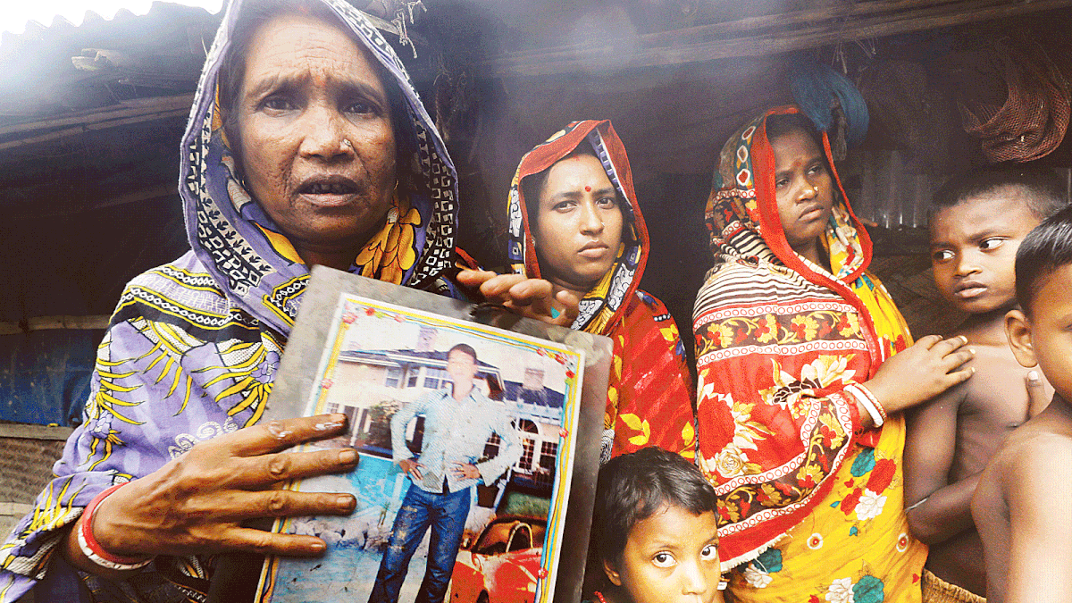 Basana Jaldas shows a photo of one of her sons who was killed by pirates. She lost two sons in the incident. Photo: Saurabh Das