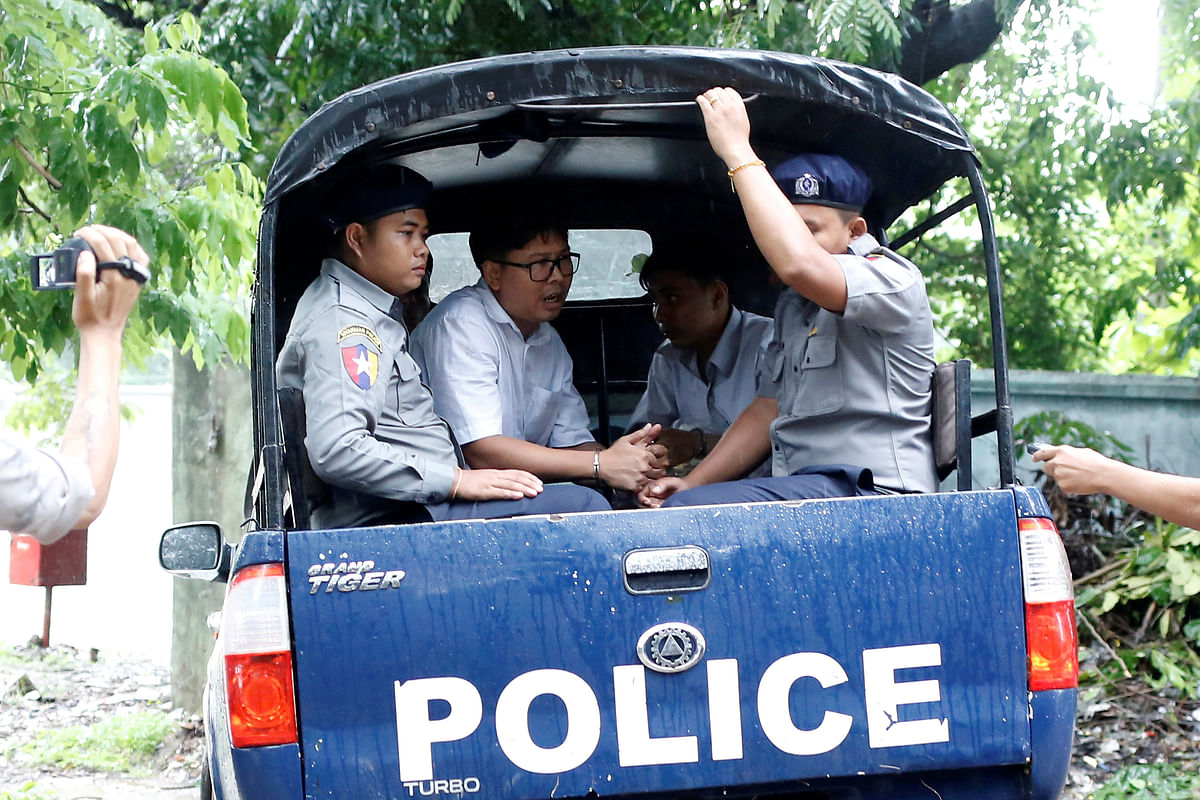 Detained Reuters journalists Wa Lone and Kyaw Soe Oo leave in a police vehicle after a court hearing in Yangon. Reuters