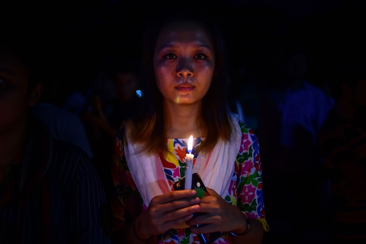A Bangladeshi indigenous woman lights a candle to mark the International Indigenous Day in Dhaka on 8 August 2018. International Day of the World`s Indigenous Peoples takes place on 9 August to promote and protect the rights of indigenous communities and cultures. Photo: AFP