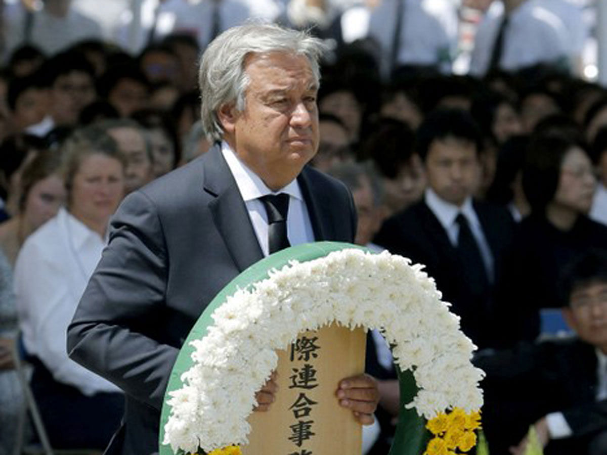 UN Secretary General Antonio Guterres offers a flower wreath for the victims of the 1945 atomic bombing during a ceremony commemorating the 73rd anniversary of the bombing at Nagasaki`s Peace Park, western Japan, in this photo taken by Kyodo on 9 August 2018. Reuters