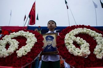 A student holds a portrait of General Aung San during a ceremony to mark the 30th anniversary of the 8888 uprising in front of city hall in Yangon on 8 August 2018. This year marks the 30th anniversary of the 8888 Uprising that took place on 8 August 1988, part of broader anti-junta demonstrations across the country that catapulted Myanmar leader Aung San Suu Kyi into the spotlight. Photo: AFP