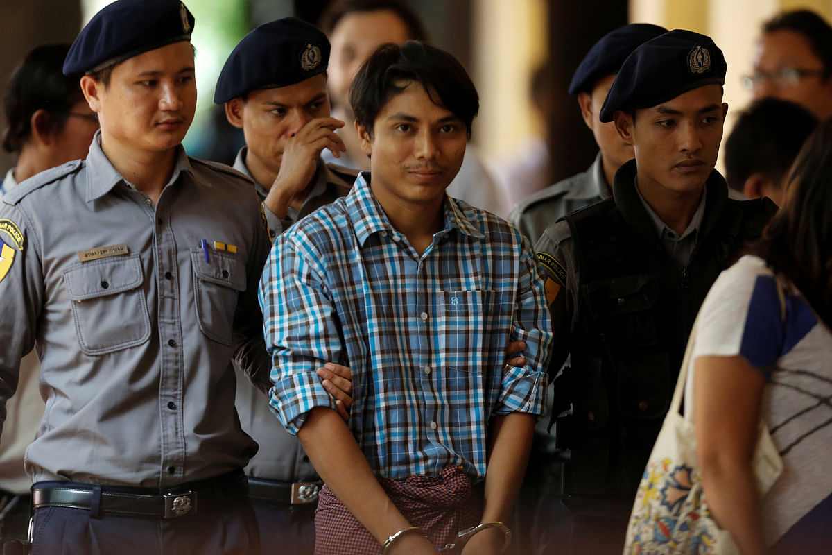 Detained Reuters journalist Kyaw Soe Oo arrives at Insein court in Yangon. Photo: Reuters