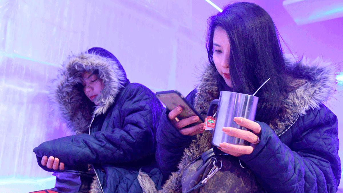 This picture taken on 24 July 2018 shows a customer enjoying her beverage in the ICE cafe in Hanoi. Photo: AFP