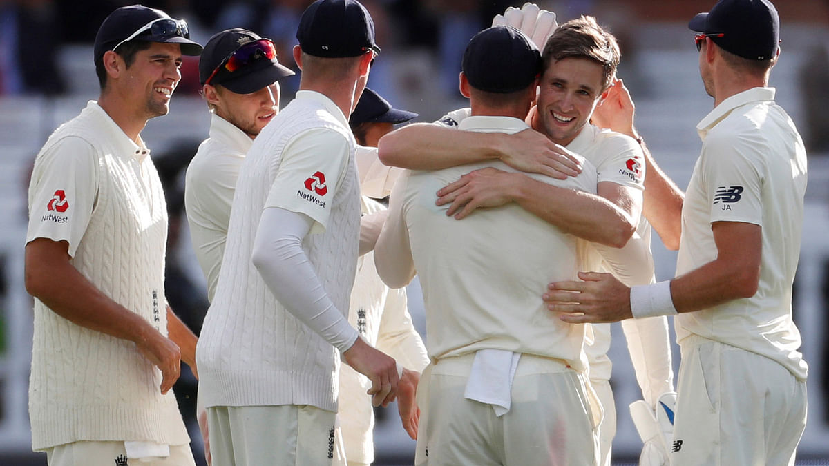 England's Chris Woakes and Jos Buttler celebrate taking the wicket of India's Virat Kohli in the Second Test at Lord’s, London, Britain on 10 August 2018. Photo: Reuters