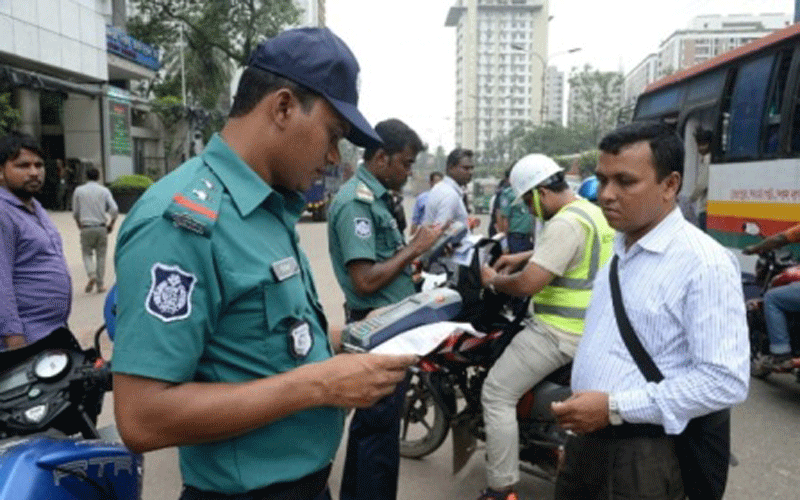 A policeman is seen taking legal action against vehicles. UNB File Photo