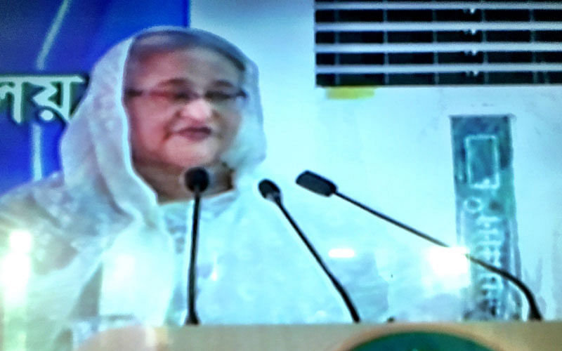 Prime minister Sheikh Hasina addresses a programme after laying foundation stone of an underpass at a road adjacent to Shaheed Ramiz Uddin Cantonment School and College in Dhaka on Sunday. Photo: Prothom Alo