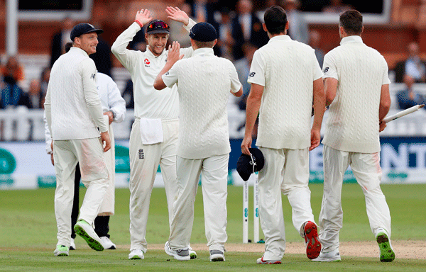 England`s Joe Root (2L) celebrates with teammates after winning the second Test cricket match between England and India at Lord`s Cricket Ground in London on 12 August 2018. England won by 159 runs. AFP