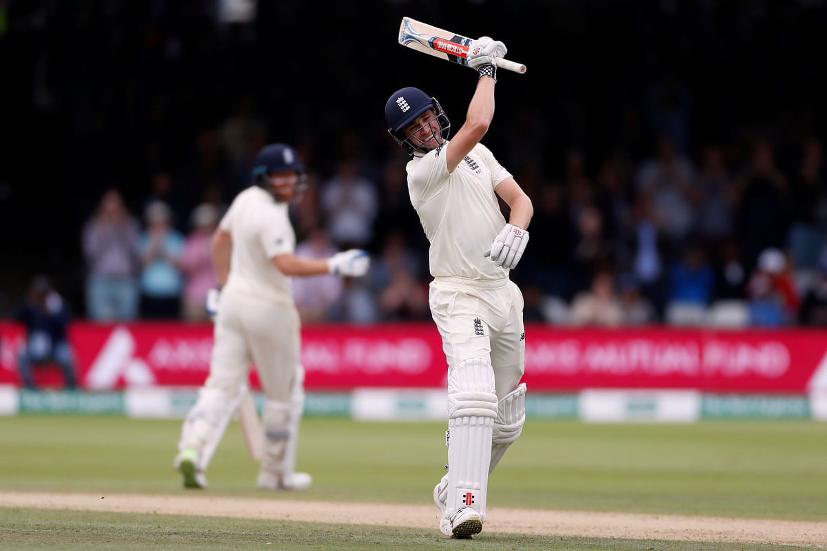 England`s Chris Woakes celebrates reaching a century against India on 11 August 11. Photo: Reuters