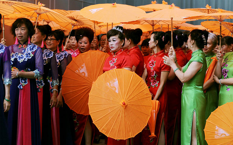 Performers wearing cheongsams wait to perform at a cultural industry expo in Kunming, Yunnan province, China on 9 August. Photo: Reuters