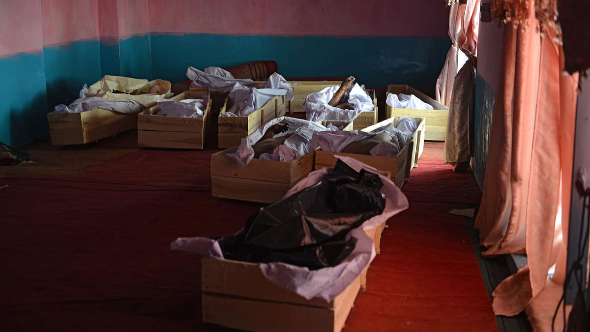 In this photo taken on 12 August 2018 coffins with corpses are seen on the floor of a mosque inside a hospital following clashes with Taliban fighters in Ghazni province. Photo: AFP
