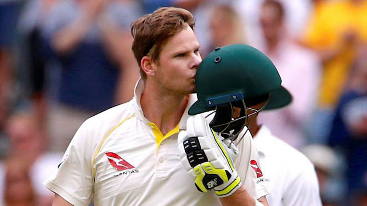 Australia`s captain Steve Smith kisses his helmet after reaching his century during the fifth day of the fourth Ashes cricket test match on 5 January 2018. Photo: Reuters