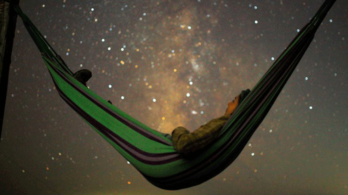 A girl lies in hammock as she looks at the milky way during the peak of Perseid meteor shower in Kozjak, Macedonia on 13 August 2018. Photo: Reuters
