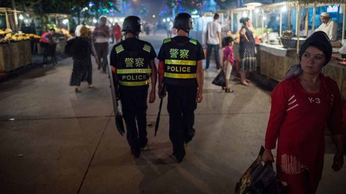 Police patrolling a night food market near the Id Kah Mosque in Kashgar in China`s Xinjiang Uighur autonomous region -- AFP