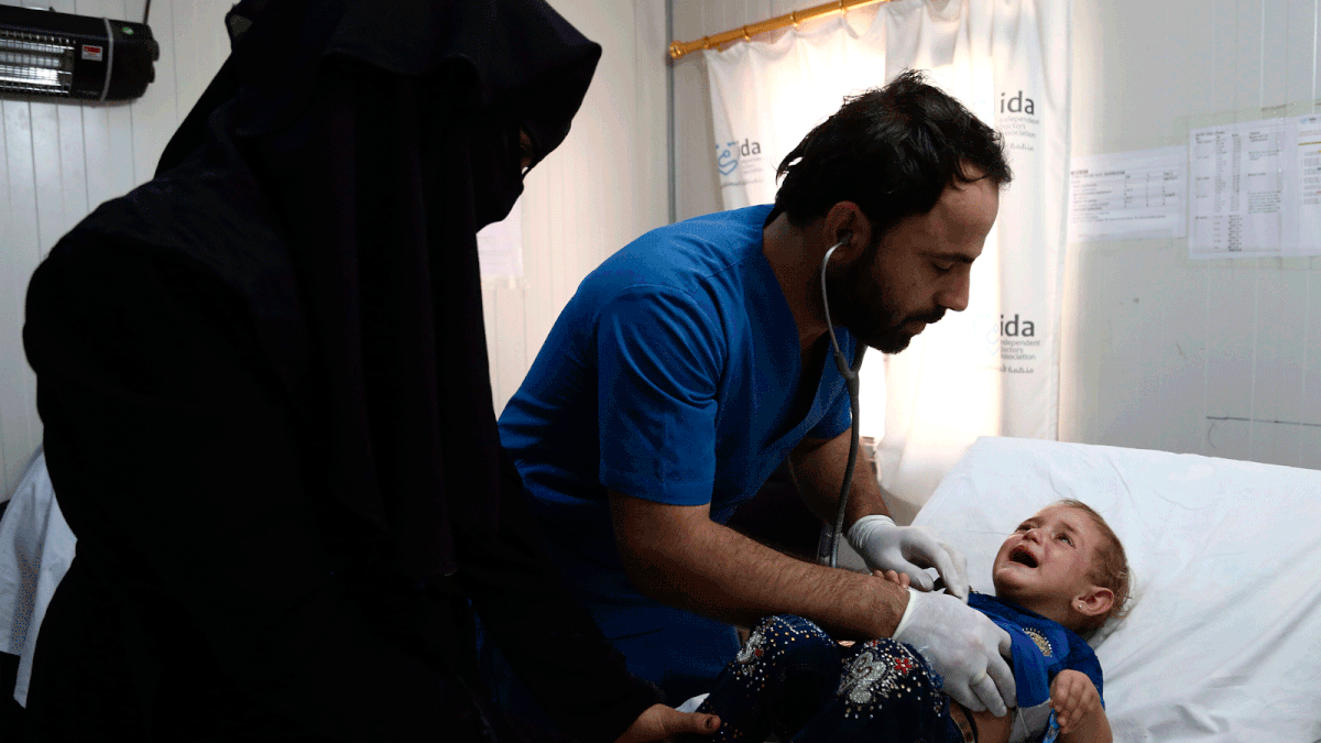 32-year-old doctor Hatem treats a child at Hope hospital in the rebel held village of Al-Ghandura, northeast of Aleppo, on 1 August. Photo: AFP