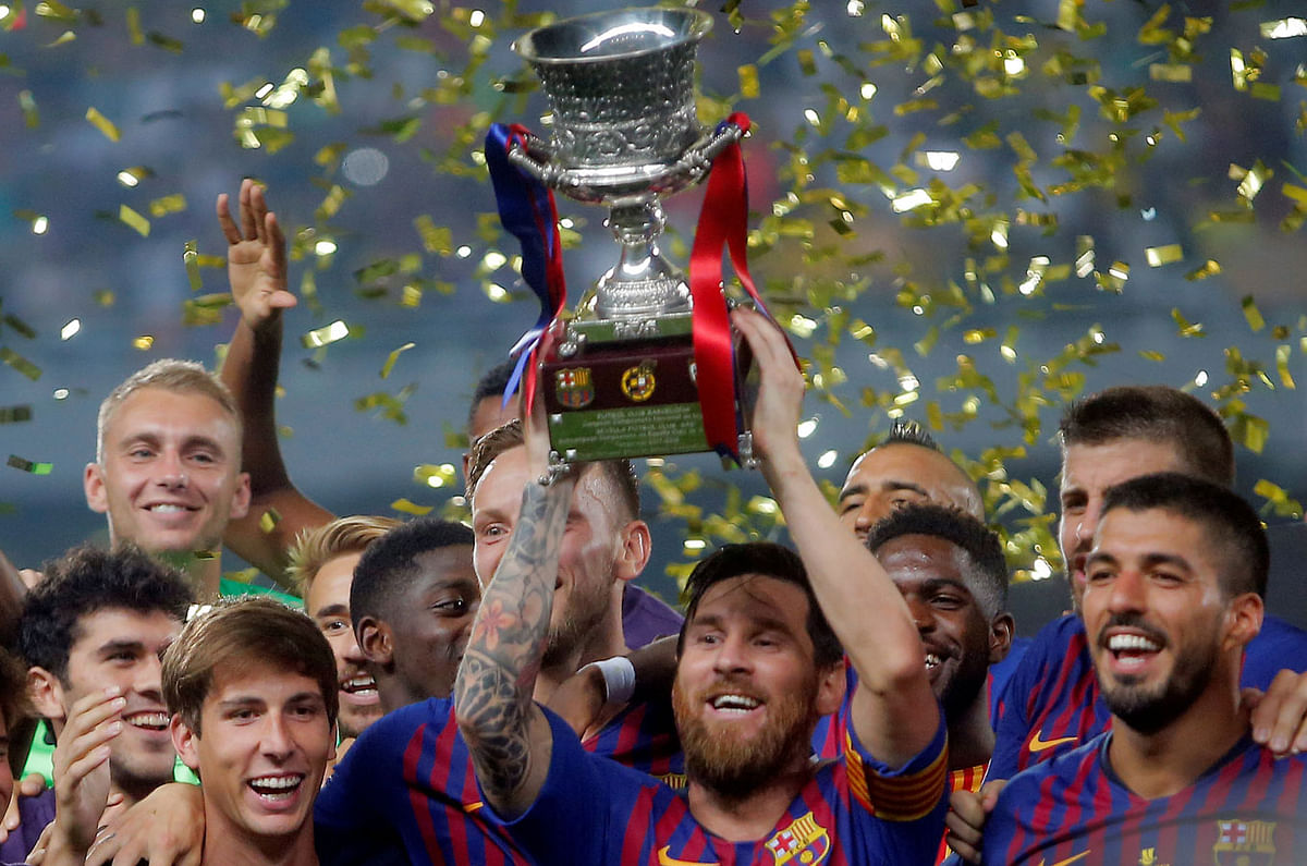 Barcelona’s Lionel Messi lifts the trophy as he celebrates winning the Spanish Super Cup with team mates at Grand Stade de Tanger, Tangier, Morocco on 12 August, 2018. Photo: Reuters