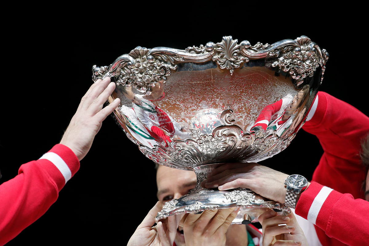 Switzerland`s team members hold the trophy after winning the Davis Cup final against France at the Pierre-Mauroy stadium in Villeneuve d`Ascq, near Lille, on 23 November 2014. Reuters File Photo