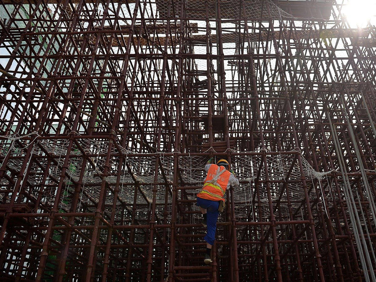 A worker climbs on steel bars at a construction site of a subway in Chengdu, Sichuan province, China on 14 August 2018. Photo: Reuters