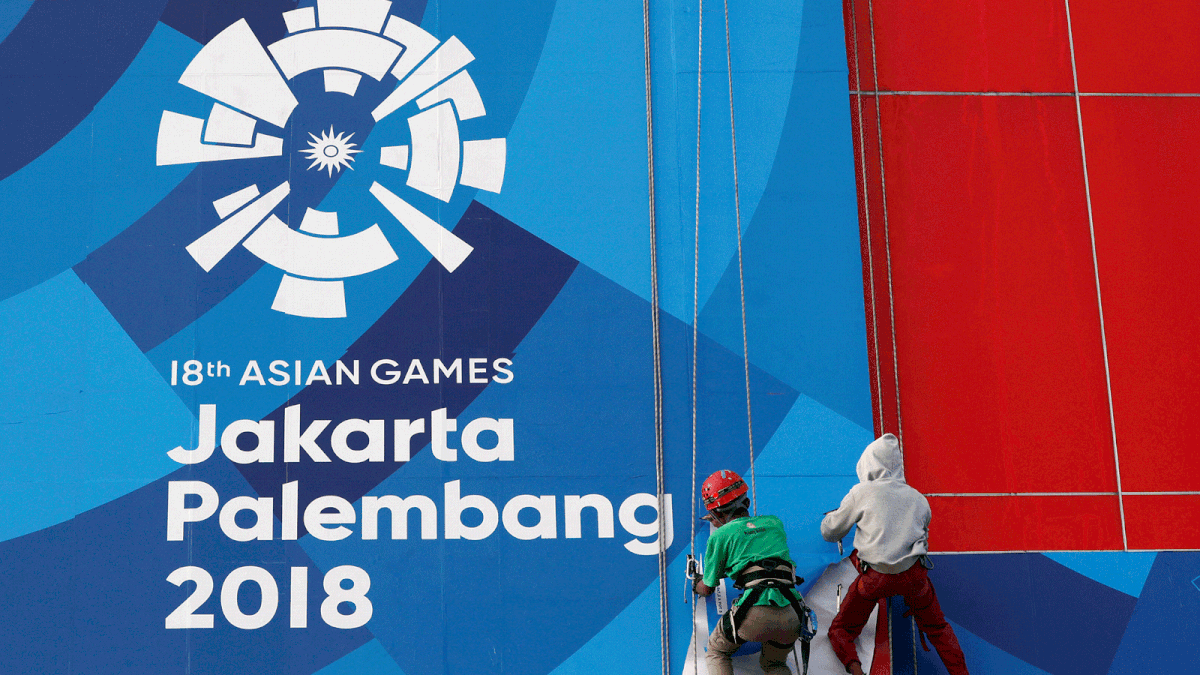 Workers prepare signages ahead of the Asian Games in Palembang. Photo: Reuters