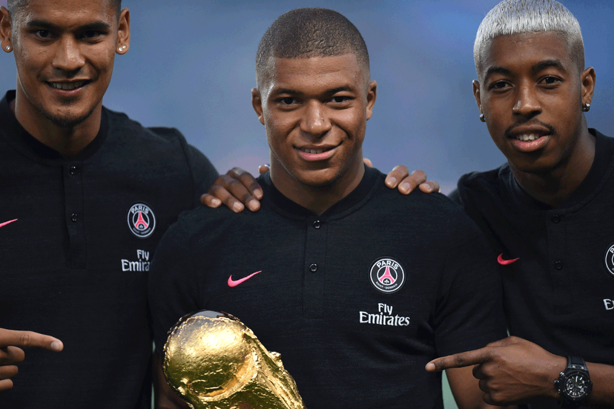 Paris Saint-Germain`s French goalkeeper Alphonse Areola, Paris Saint-Germain`s French forward Kylian Mbappe and Paris Saint-Germain`s French defender Presnel Kimpembe pose with the 2018 World Cup Trophy prior to the French L1 football match between Paris Saint-Germain and Caen on 12 August, 2018 at the Parc des Princes, in Paris. Photo: AFP