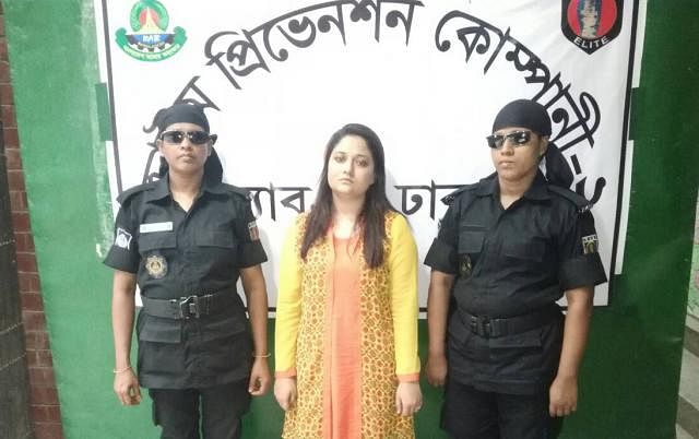 RAB detains Faria Mahzabin (C) for allegedly spreading rumour on Facebook.