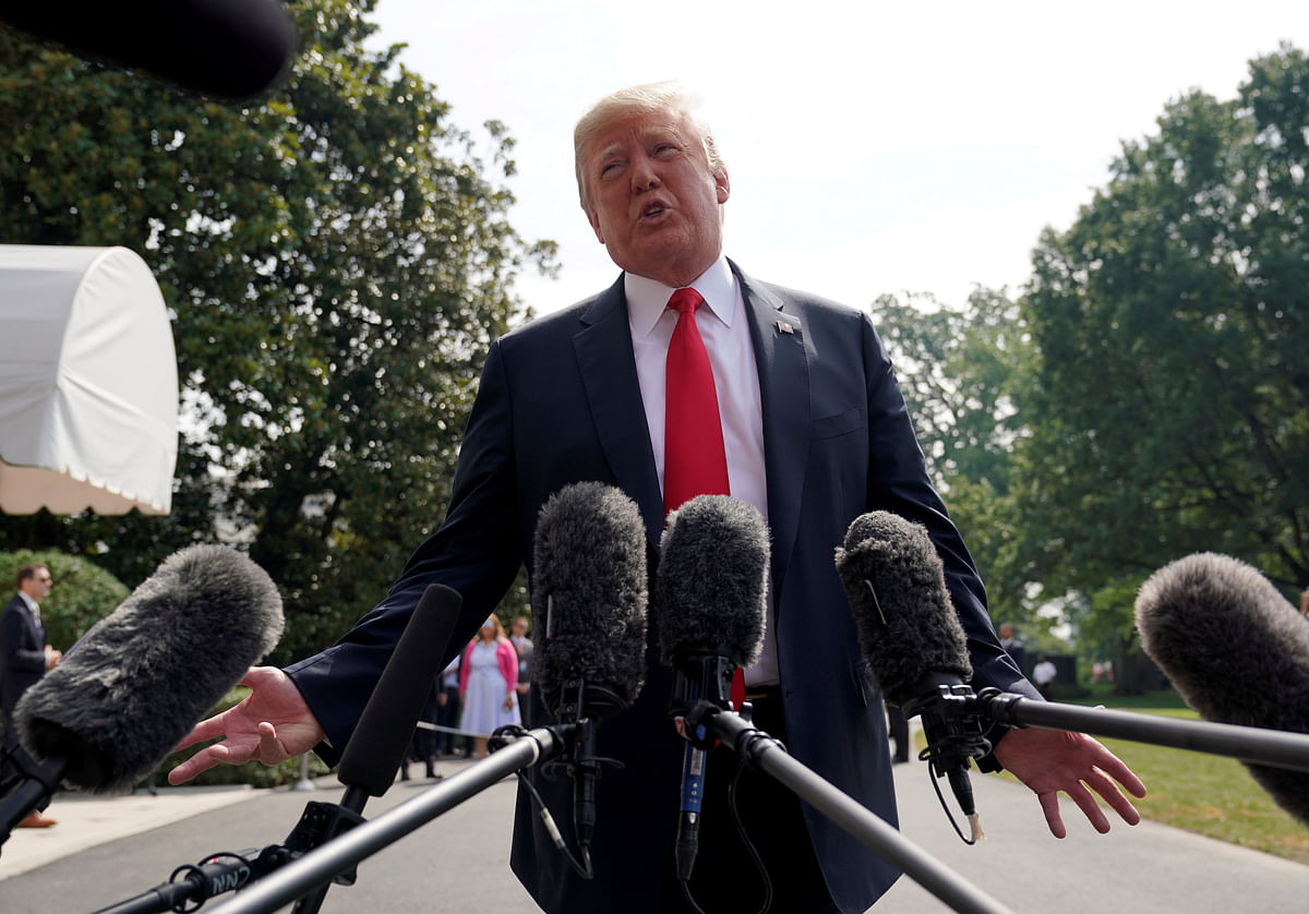 US president Donald Trump speaks to reporters upon his departure from the White House in Washington, US, on 17 August 2018. Reuters