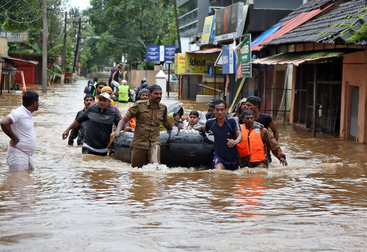 Rescuers evacuate people from a flooded area to a safer place in Aluva in the southern state of Kerala, India, on 18 August 2018. Reuters