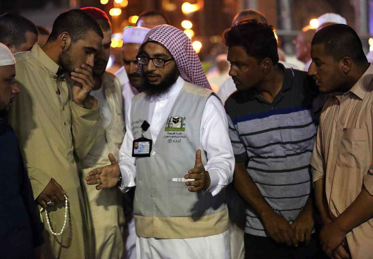 Muslim pilgrims speak to a translator in the Saudi holy city of Mecca, ahead of the start of the Hajj pilgrimage, on 17 August 2018. Photo: AFP