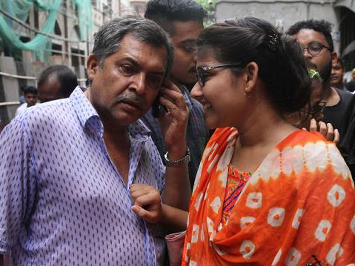 Father is conveying news of son Zahidul Haque`s bail to relatives over phone and his (Zahidul) sister in smiling face beside her father at the CMM court on 19 August (Sunday). Photo: Dipu Malakar