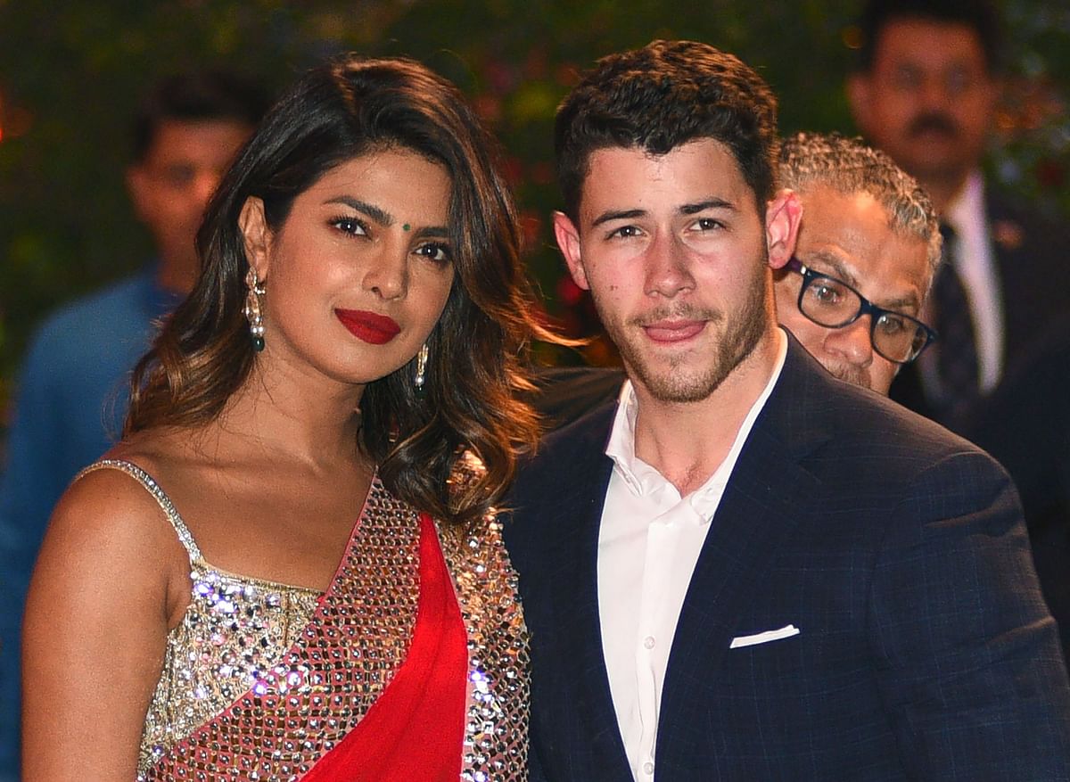 In this file photo taken on 28 June, 2018, Indian actress Priyanka Chopra (L) accompanied by Nick Jonas arrive for the pre-engagement party of India`s richest man and Reliance Industries Limited chairman, Mukesh Ambani’s eldest son Akash Ambani and fiancee Shloka Mehta in Mumbai. Photo: AFP
