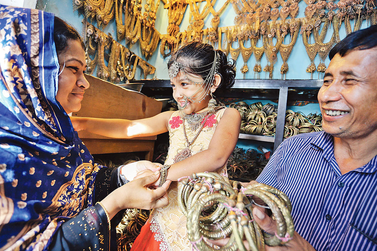 A child is seen smiling adorned with jewellery ornaments at a shop. The photo is recently taken from Savar’s Bhakurta union parishad. Photo: Zahidul Karim