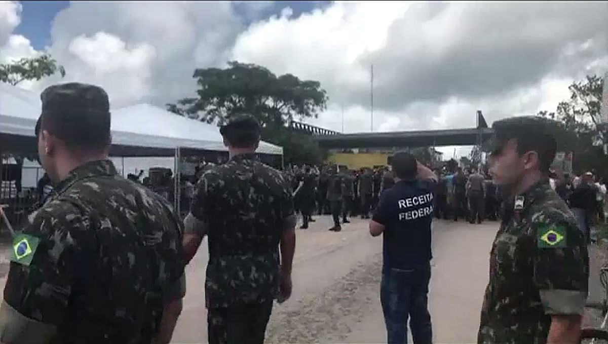 Screen grab taken from a AFP video showing Brazilia police and military presence at the border in the Brazilian border town of Pacaraima after residents attacked the two main makeshift camps of Venezuelan immigrants and burned their belongings, leading them to cross the border back into their home country, on 18 August. Photo: AFP