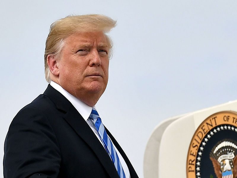 In this file photo taken on 21 August 2018, US president Donald Tump boards Air Force One before departing from Andrews Air Force Base in Maryland. Trump said in an interview aired on 23 August 2018, that the US economy would collapse if he were impeached. `I will tell you what, if I ever got impeached, I think the market would crash. I think everybody would be very poor,` Trump told Fox and Friends. -- Photo: AFP