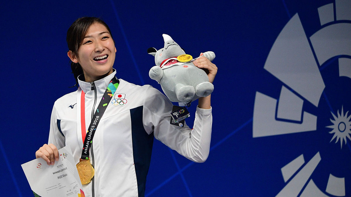 Gold medallist Japan`s Rikako Ikee celebrates during the victory ceremony for the women’s 50m freestyle swimming event during the 2018 Asian Games in Jakarta on 24 August 2018. Photo: AFP