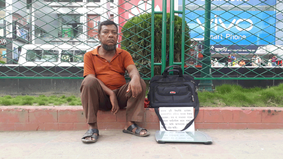 Abdur Rahim with his digital weight scale in front of Bashundhara City, Dhaka on 17 August. Photo: Shameem Reza