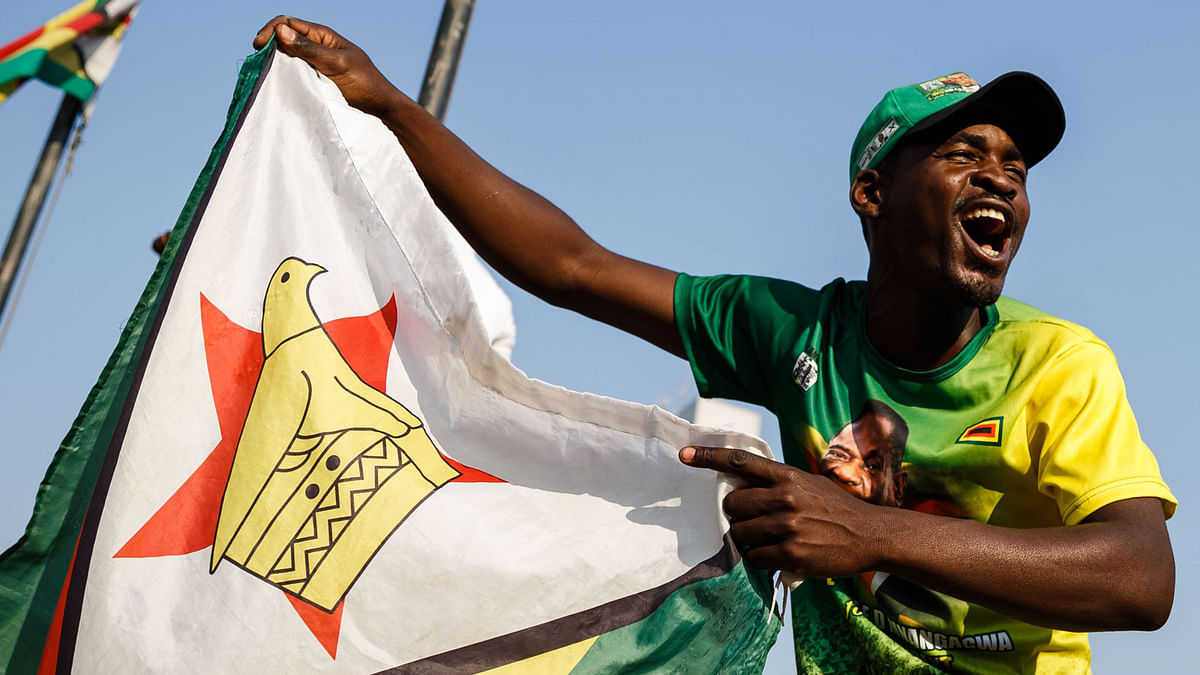 A man waves the national flag of Zimbabwe on 24 August 2018 in Harare. Photo: AFP