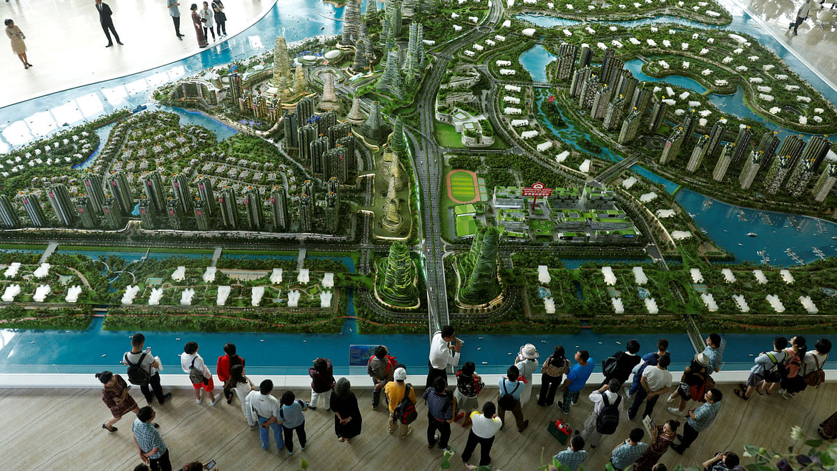 Prospective buyers look at a model of the development at the Country Gardens` Forest City showroom in Johor Bahru. Photo: Reuters