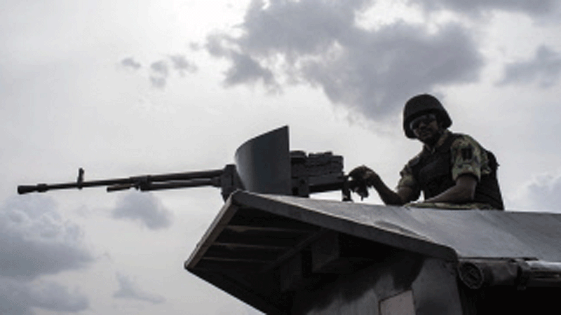 In this file photo taken on 17 April 2018 a member of the Nigerian Military Police sits on an armoured vehicle during the African Land Forces Summit (ALFS) military demonstration held at General Ao Azazi barracks in Gwagwalada. At least 30 Nigerian soldiers died in combat with Boko Haram jihadists who overran a military base in the northeast near the border with Niger, two military sources told AFP on 1 September 2018. Scores of jihadists in trucks stormed the base at Zari village in northern Borno state late Thursday and briefly seized it after a fierce battle, they said. Photo: AFP