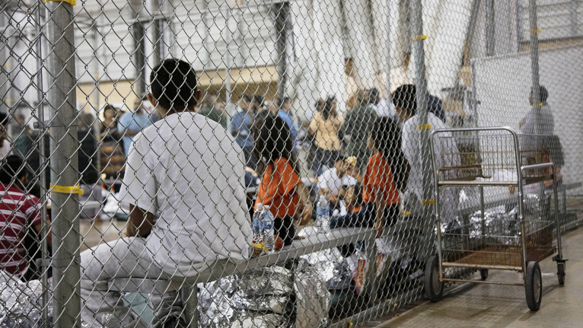 In this 17 June, 2018 file photo provided by US Customs and Border Protection, people who’ve been taken into custody related to cases of illegal entry into the United States, sit in one of the cages at a facility in McAllen, Texas. Photo: AP
