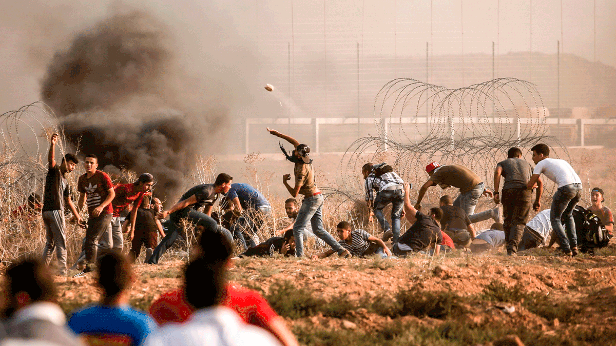 A Palestinian protester throws a stone during a demonstration near the border with Israel, east of Gaza City, on 31 August. Photo: AFP