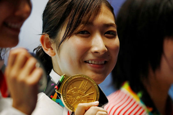 Japan`s Rikako Ikee celebrates with her medal after winning the Women`s 50m Freestyle. Photo: Reuters