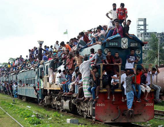 People clamber all over the Dhaka-bound train from Mymensingh railway station, risking their lives to return home after the Eid vacation on 2 September. Photo: Anwar Hossain