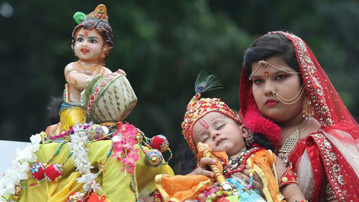 A girl dressed as Yashoda, foster mother of Lord Krishna, holds the sleeping child dressed as Krishna during a rally commemorating the major Hindu deity’s birthday on 2 September. Doel Chattar, Dhaka, 2 September. Photo: Abdus Salam