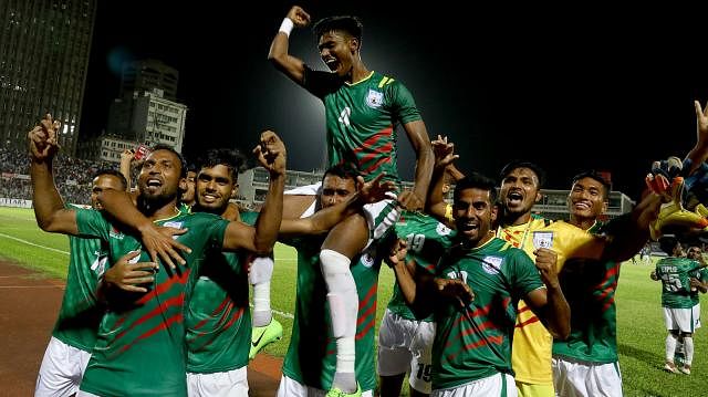 Bangladesh defender Topu Barman celebrates victory with teammates on Thursday at Bangabandhu National Stadium in Dhaka. Photo: Shamsul Haque