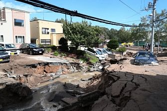 A car (R) is stuck on a road damaged by an earthquake in Sapporo, Hokkaido prefecture on 6 September 2018. A powerful 6.6-magnitude quake rocked the northern Japanese island of Hokkaido on 6 September triggering landslides, collapsing buildings, and killing at least two people with several dozen missing. Photo: AFP