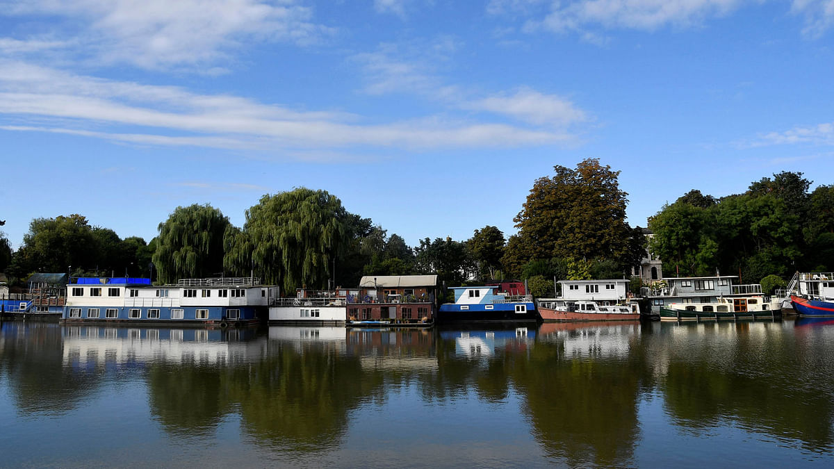 Houseboats are seen reflected in the water, moored on the River Thames at Richmond in west London, Britain. Photo: Reuters
