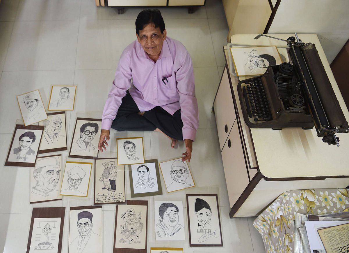 In this photograph taken on 17 July 2018, Indian artist Chandrakant Bhide poses with artwork showing various portraits of public figures and deities which he created using a typewriter, during an interview with AFP in Mumbai. Photo: AFP