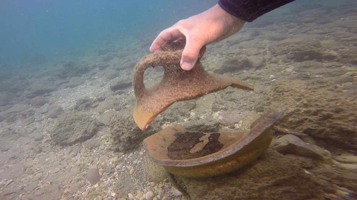 A marine archaeologist looks for relics in the Mediterranean Sea close to the site of a 5000-year-old port near Dor Beach in northern Israel, in this still image taken from handout video provided to Reuters on 30 August 2018. Photo: Reuters