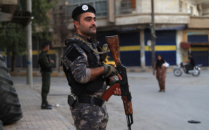 Members of the Kurdish Internal Security Police Force of Asayish keep watch during a security alert after clashes with regime forces in Qamishli, northeastern Syria, on 8 September. Photo: AFP